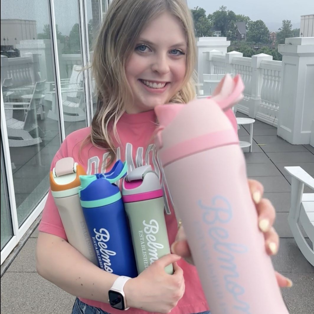 Belmont student holding new Belmont BruinShop pop top water bottles. Click here to view Instagram post