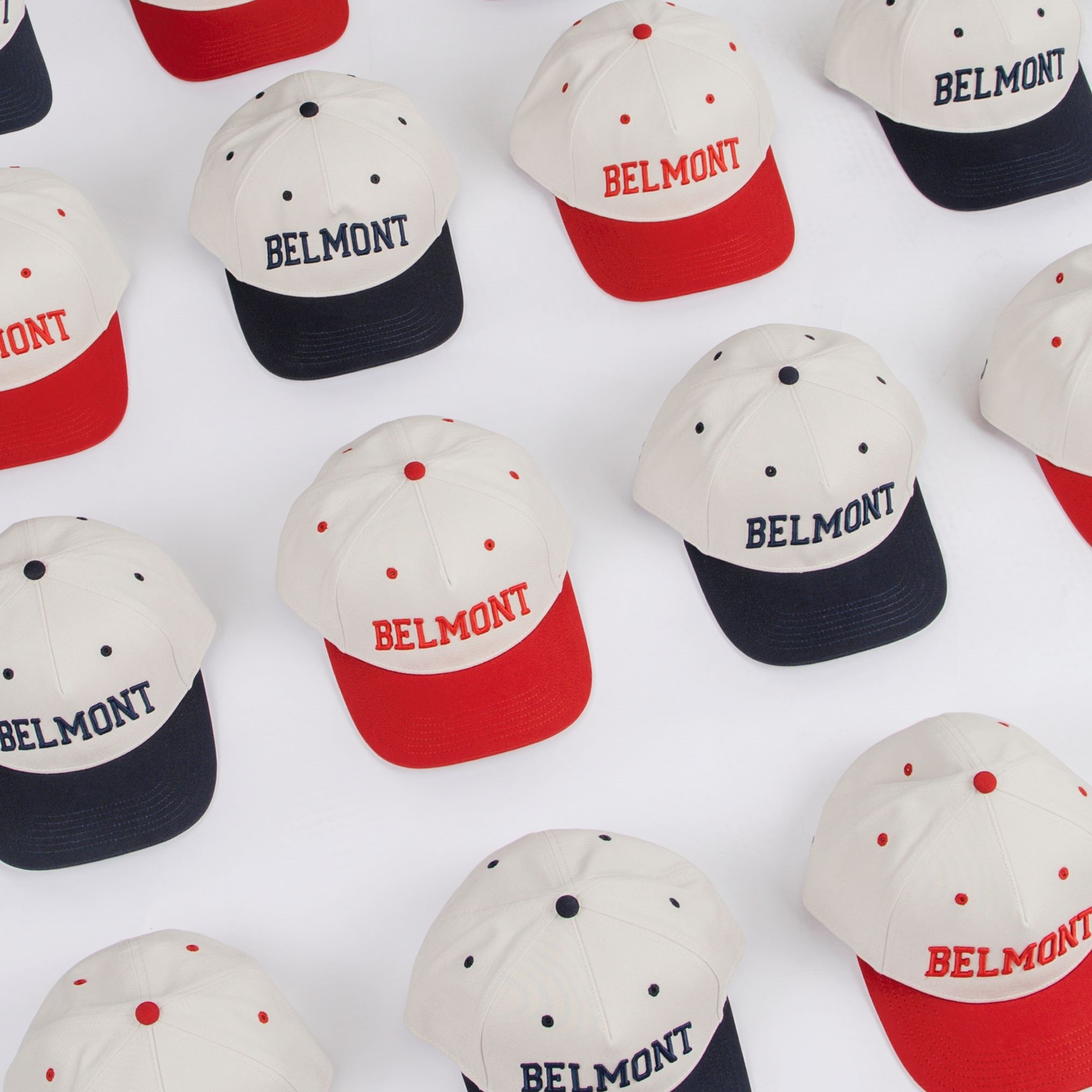 Image of Belmont BruinShop's red and navy two-tone caps. Click to view Instagram post