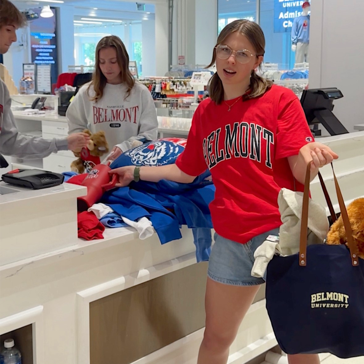 Customer buying multiple sweatshirts, a tumbler, a tote bag, stuffed bear, and more at the BruinShop. Click to view Instagram post