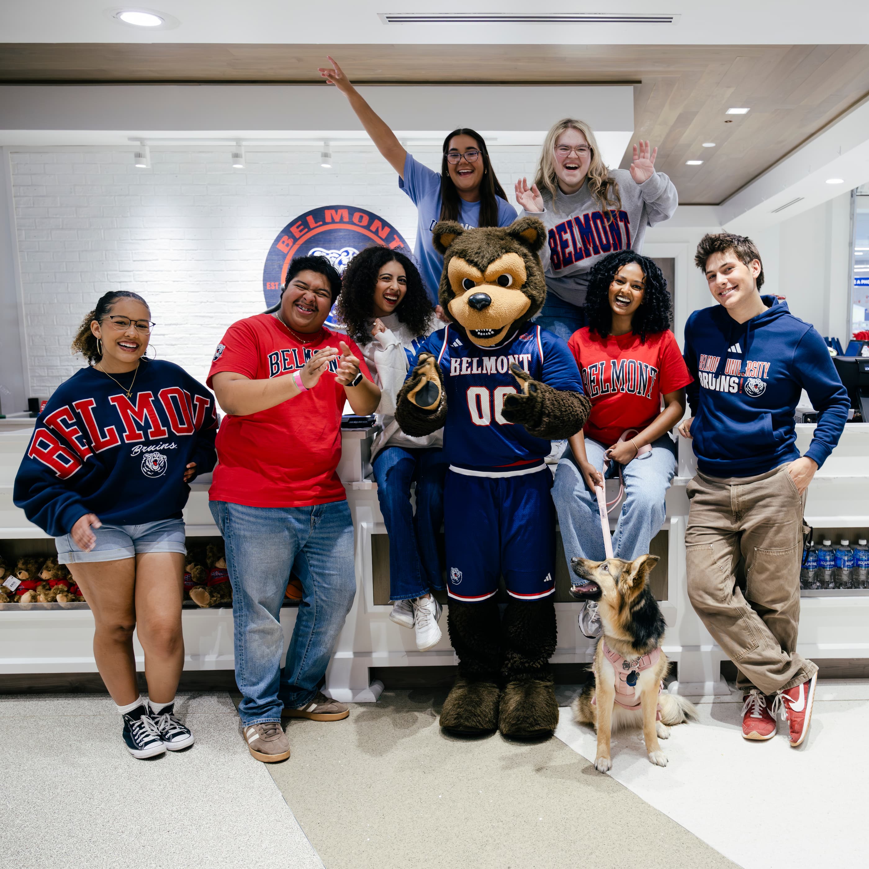 Students wearing various BruinShop gear and posing with Belmont's mascot, Bruiser. Click to view Instagram post
