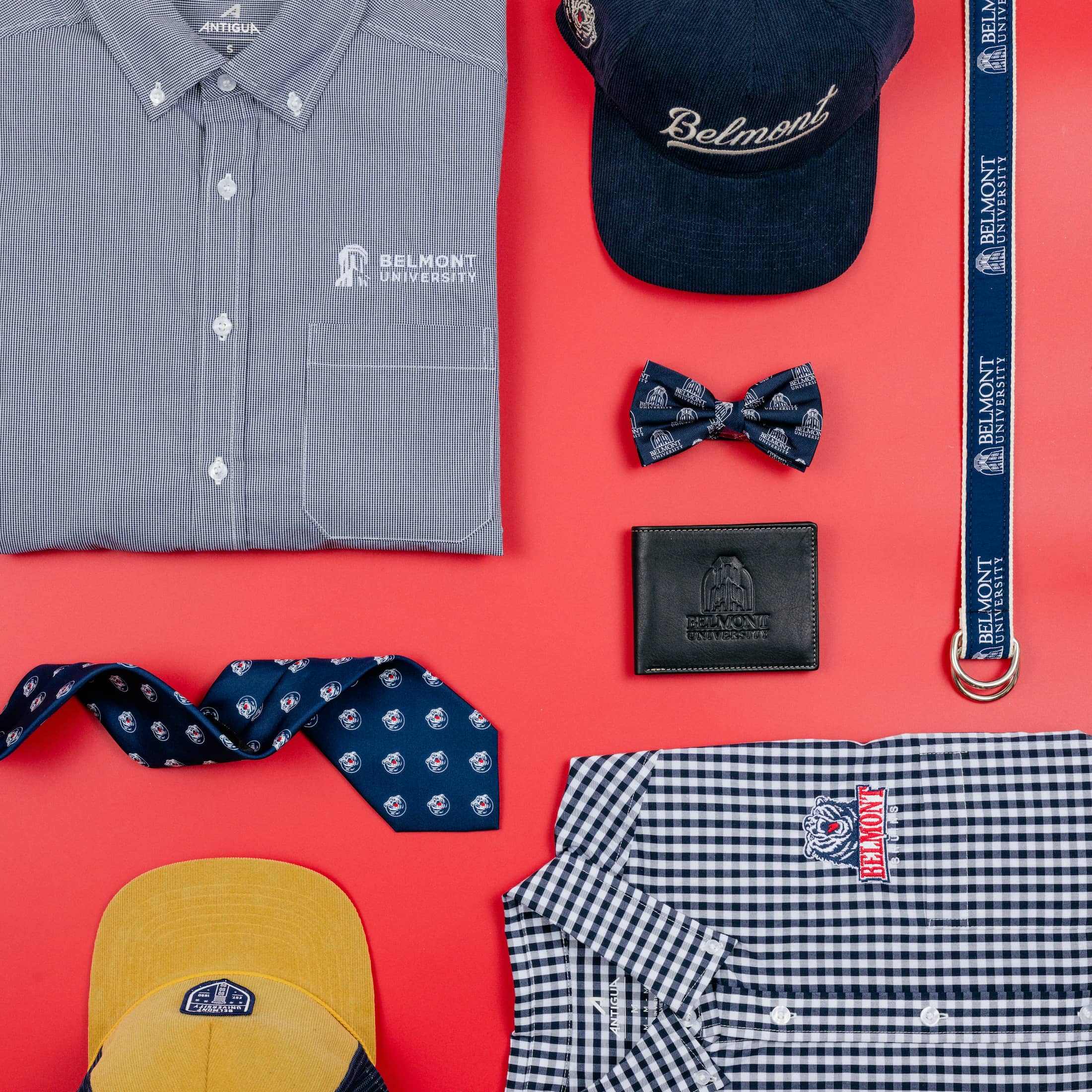 BruinShop button up shirt, tie, bowtie, hat, wallet, and lanyard sitting on a table. Click to view Instagram post